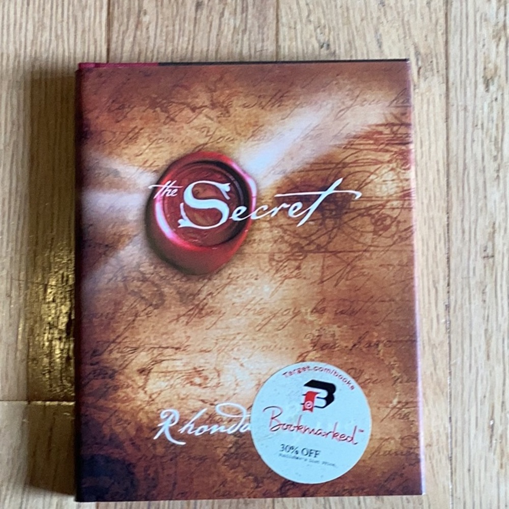The Secret hard back with paper cover,  brand new.